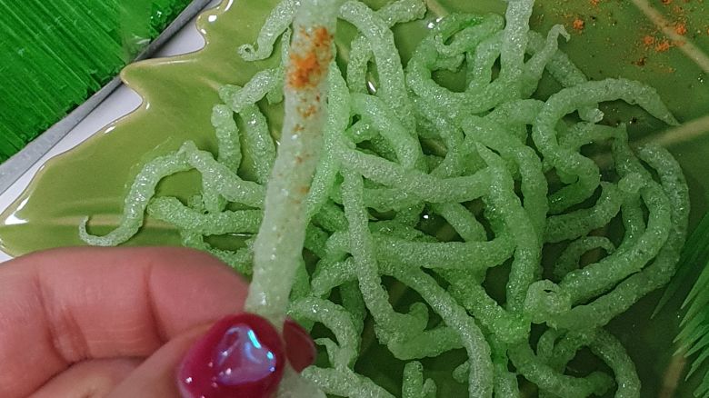A person holds a "Fried green toothpick" which went viral following a social media trend.