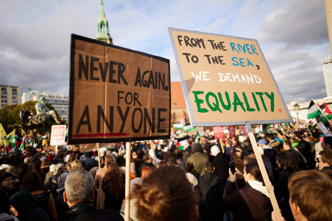 People at a pro-Palestine rally in Berlin hold a banner reading "From the river to the sea, we demand equality."