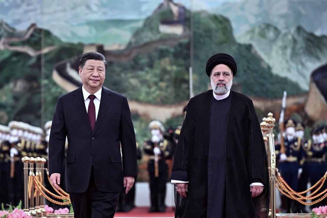 In this photo released by Xinhua News Agency, Visiting Iranian President Ebrahim Raisi, right, walks with Chinese President Xi Jinping after reviewing an honor guard during a welcome ceremony at the Great Hall of the People in Beijing, Tuesday, Feb. 14, 2023.