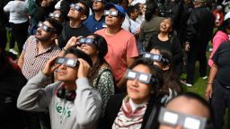 People watch the annular solar eclipse at the Luis Enrique Erro Planetarium of the National Polytechnic Institute (IPN) in Mexico City on October 14, 2023. Skygazers across the Americas turned their faces upwards Saturday for a rare celestial event: an annular solar eclipse.