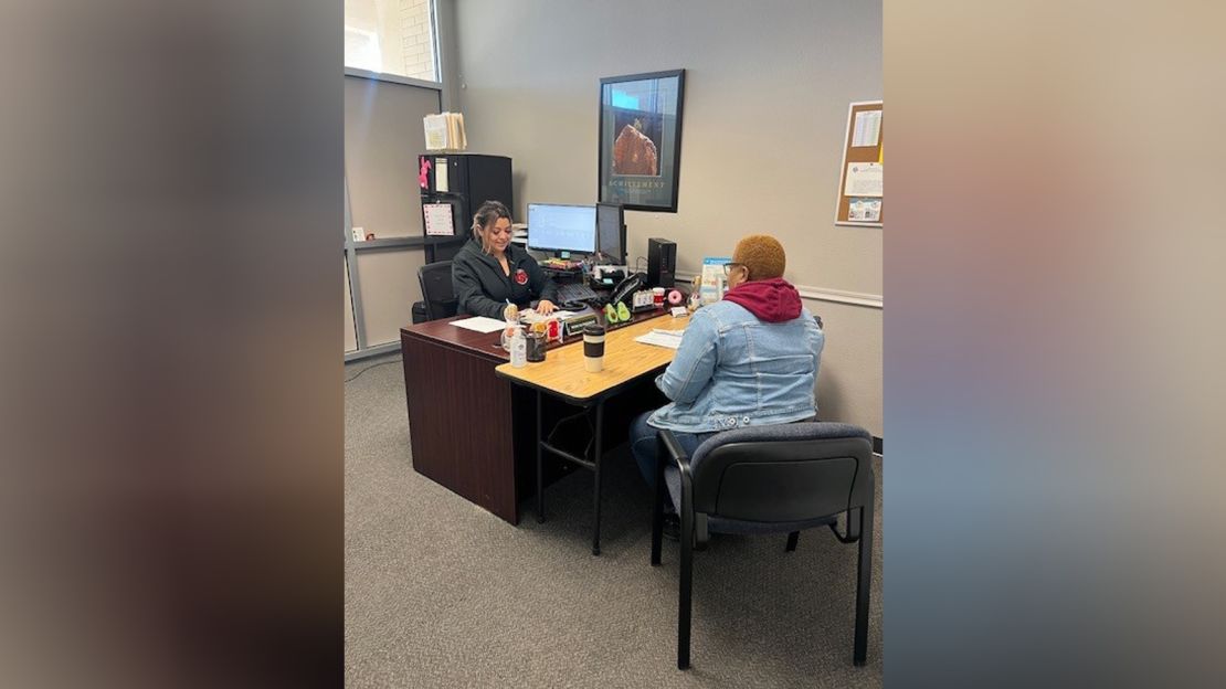 This picture shows a worker at Merced County Community Action Agency helping a woman applying for LIHEAP.