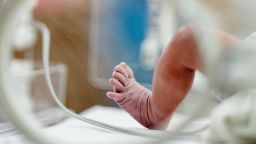 Selective focus Asian newborn foot with pulse sensor for monitor and moving in the incubator the first day in the world - stock photo