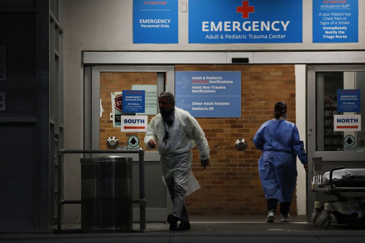 Medical workers are seen outside a special coronavirus area at Maimonides Medical Center in Brooklyn, New York, on May 6.