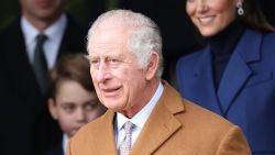 Britain's King Charles III waits on the church steps after attending the Royal Family's traditional Christmas Day service at St Mary Magdalene Church on the Sandringham Estate in eastern England, on December 25, 2023. (Photo by Adrian DENNIS / AFP) (Photo by ADRIAN DENNIS/AFP via Getty Images)