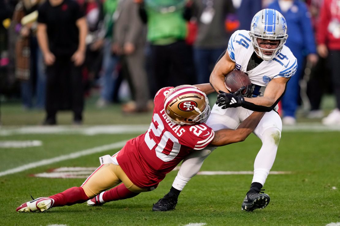 Detroit Lions wide receiver Amon-Ra St. Brown is tackled by San Francisco 49ers cornerback Ambry Thomas during the first half of the NFC Championship NFL football game in Santa Clara, Calif., Sunday, Jan. 28, 2024. (AP Photo/David J. Phillip)