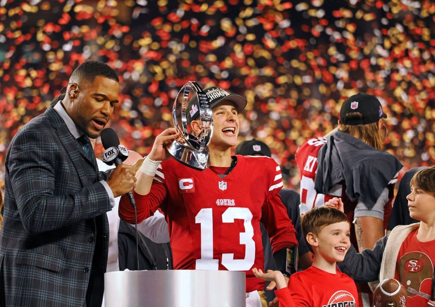 49ers quarterback Brock Purdy holds the George Halas Trophy after winning the NFC championship game on January 28. The 49ers beat the Detroit Lions 34-31.