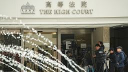 Media members stand outside the High Court where a court hearing on property developer China Evergrande Group is held, in Hong Kong, China January 29, 2024.