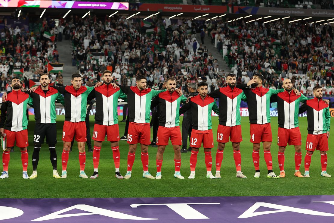 AL RAYYAN, QATAR - JANUARY 14: Palestine players observe the national anthems prior to the AFC Asian Cup Group C match between Iran and Palestine at Education City Stadium on January 14, 2024 in Al Rayyan, Qatar. (Photo by Robert Cianflone/Getty Images)
