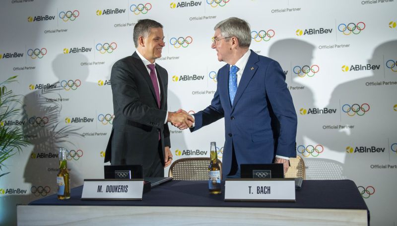 AB InBev CEO Michel Doukeris and IOC President Thomas Bach shake hands during an announcement event in London.