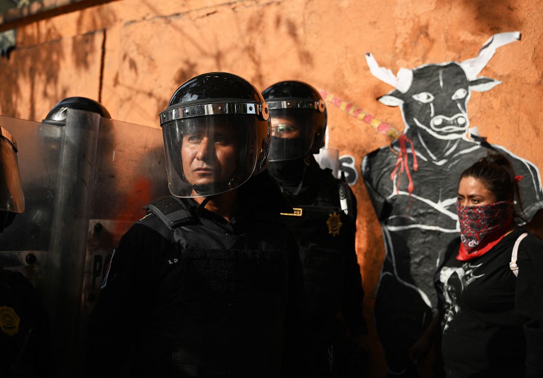 TOPSHOT - Riot police stand guard at the gate of the Monumental Plaza de Toros Mexico during a protest against bullfights in Mexico City, Mexico, on January 28, 2024. Activists protested on Sunday against a resumption of bullfighting in Mexico City, after the Supreme Court revoked an earlier suspension. (Photo by CARL DE SOUZA / AFP) (Photo by CARL DE SOUZA/AFP via Getty Images)