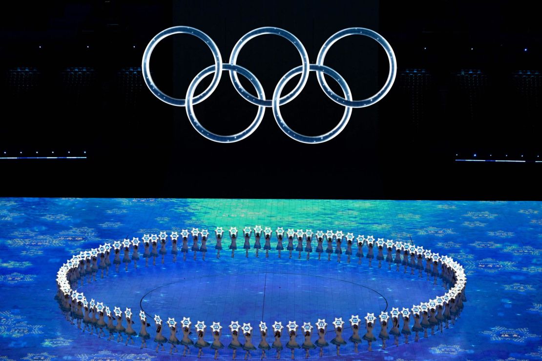 A general view shows performers hold signs with the name of participating countries under the Olympic rings during the opening ceremony of the Beijing 2022 Winter Olympic Games, at the National Stadium, known as the Bird's Nest, in Beijing, on February 4, 2022.