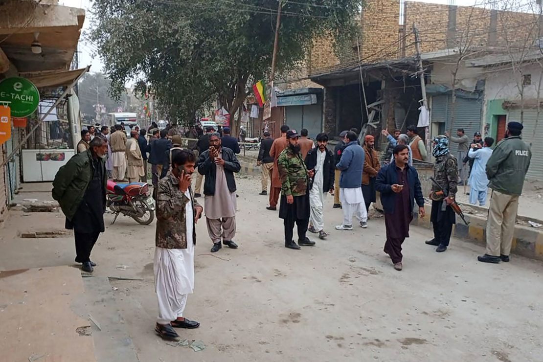 Security personnel and people gather near the site of a bomb explosion at Sibi, in Balochistan province on January 30, 2024. Police in the Balochistan provincial capital of Quetta said a bomb planted on a motorbike detonated on January 30 killing at least four people, as supporters rallied for the Pakistan Tehreek-e-Insaf (PTI) party of jailed ex-prime minister Imran Khan, ahead of polls next week. (Photo by AFP) (Photo by -/AFP via Getty Images)