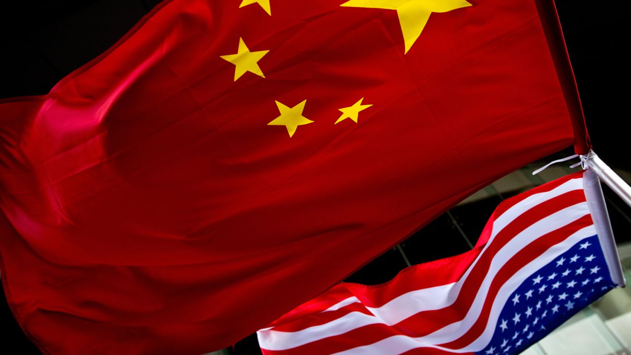 U.S. and Chinese national flags are seen outside a hotel in Beijing on November 7, 2012.