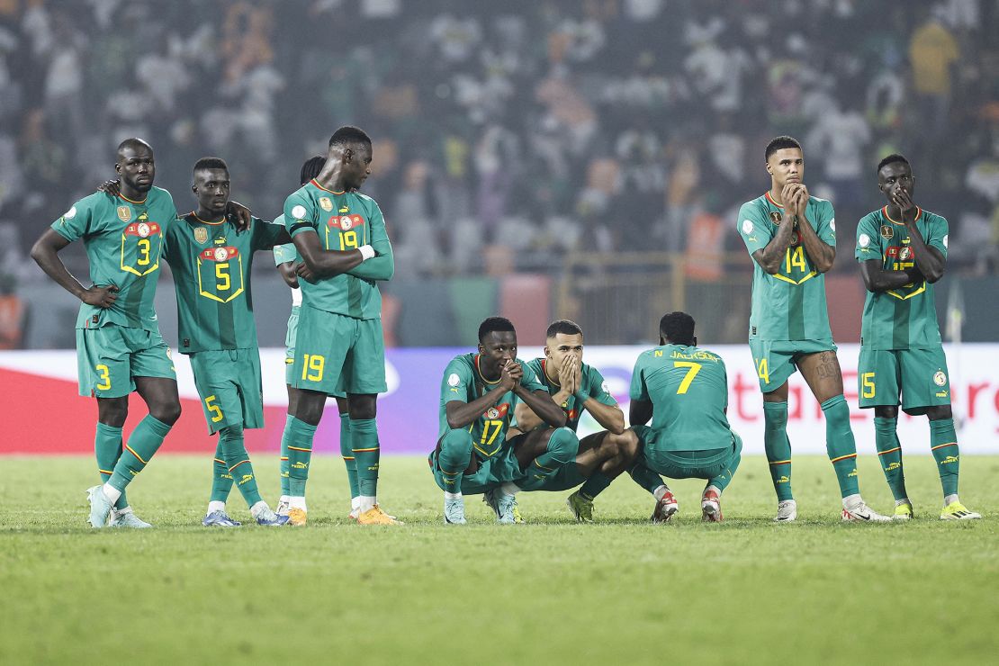 Senegal's players react as they stand next to the penalty spot during the extra time of the Africa Cup of Nations (CAN) 2024 round of 16 football match between Senegal and Ivory Coast at the Stade Charles Konan Banny in Yamoussoukro on January 29, 2024. (Photo by KENZO TRIBOUILLARD / AFP) (Photo by KENZO TRIBOUILLARD/AFP via Getty Images)