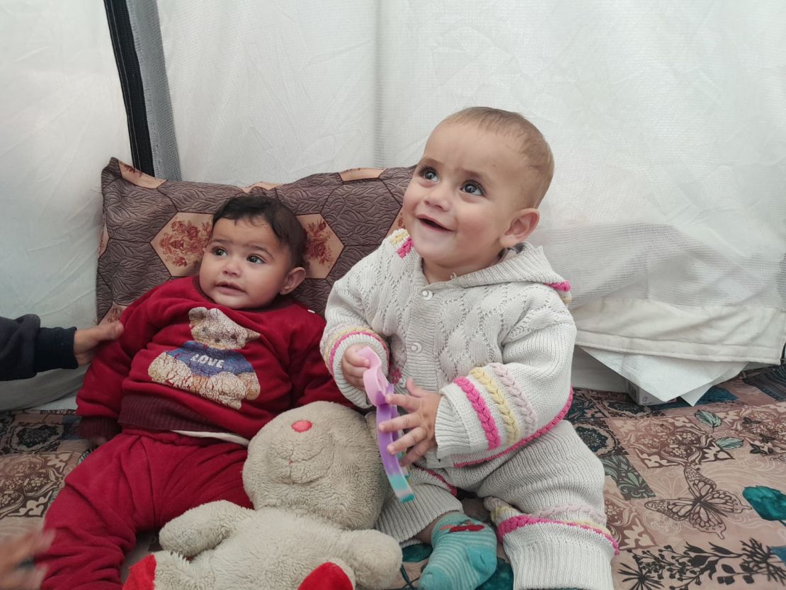 Infant orphans Hoor (left) and Kanan (right) shelter inside a tent in a displacement camp in Rafah, southern Gaza, on January 25, 2024.