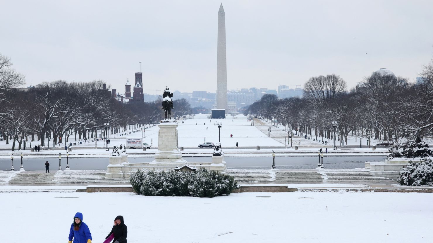 People sled on a hill on a snowy day outside of the U.S. Capitol building looking towards the National Mall in Washington, U.S., January 16, 2024.