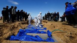 People bury Palestinians, including those who were killed in Israeli strikes and fire, after their bodies were released by Israel, according to Palestinian health ministry officials, amid the ongoing conflict between Israel and the Palestinian Islamist group Hamas, at a mass grave in Rafah, in the southern Gaza Strip, January 30, 2024. REUTERS/Mohammed Salem