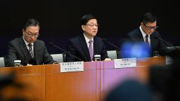 Hong Kong Chief Executive John Lee (C), Secretary for Justice Paul Lam (L) and Secretary for Security Chris Tang (R) hold a press conference at government headquarters in Hong Kong on January 30, 2024.