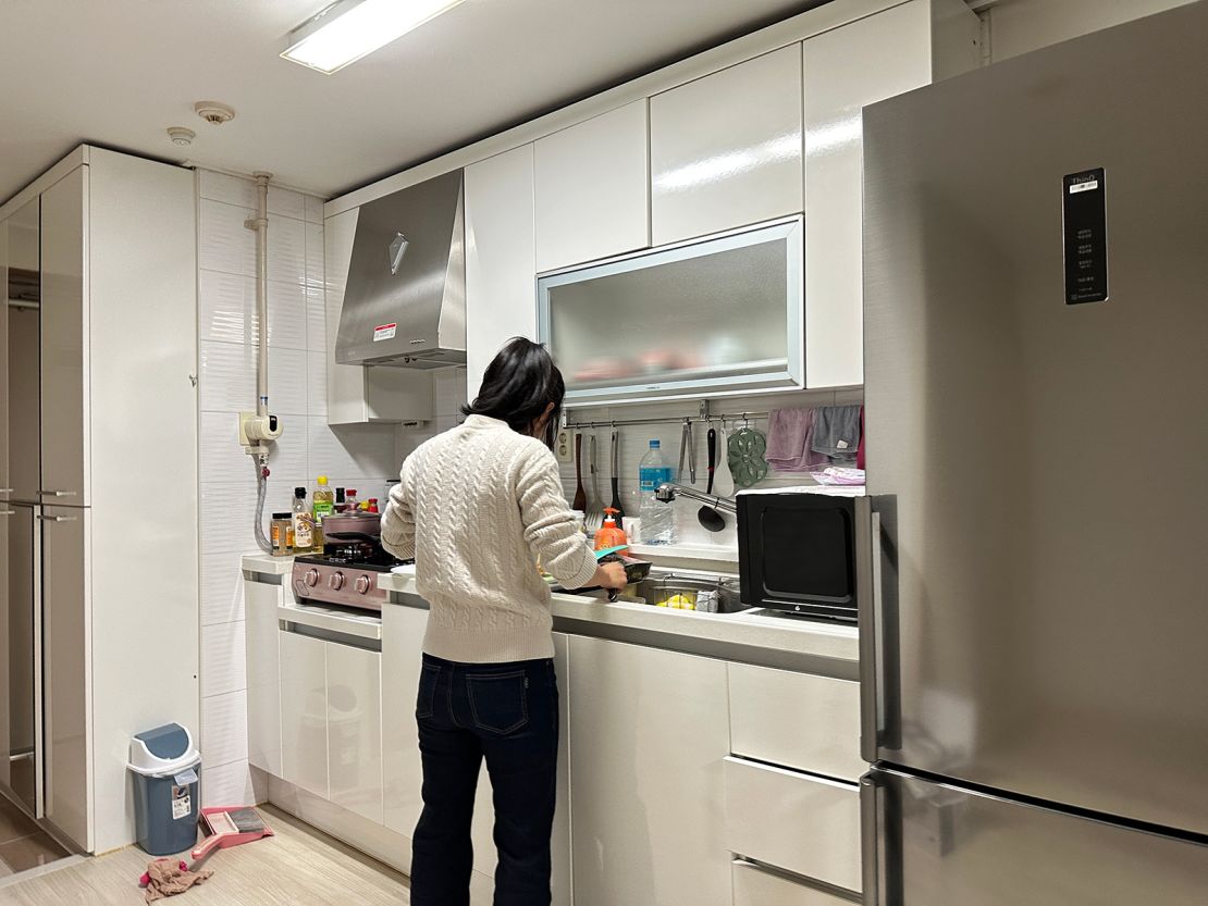 North Korean refugee, who was trafficked into forced marriage in China and lived there for a long time before escaping to South Korea, prepares her meal at her home in South Korea.