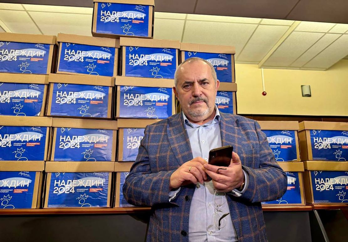 Boris Nadezdhin standing in front of boxes with 105,000 signatures collected in support of his presidential bid