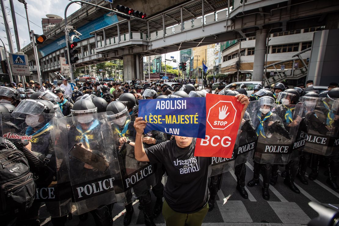 A pro-democracy protester holds a placard with the words "Abolish Lèse-majesté Law" during an anti-government demonstration in Bangkok, Thailand on November 17, 2022.