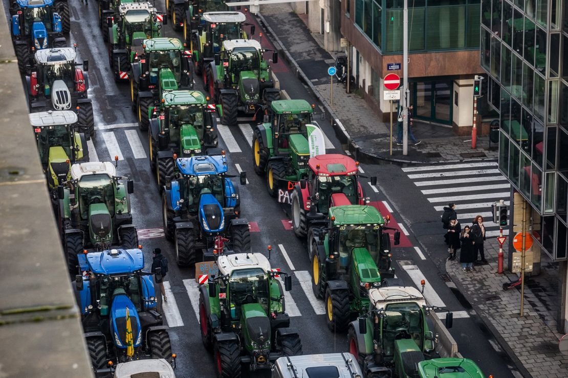 TOPSHOT - This photograph taken on February 1, 2024, shows rows of tractors between buildings in the Belliard street during a protest action in the European district in Brussels, organised by general farmers union ABS (Algemeen Boerensyndicaat) to demand better conditions to grow, produce and maintain a proper income, on the day of a European Council meeting. (Photo by HATIM KAGHAT / Belga / AFP) / Belgium OUT (Photo by HATIM KAGHAT/Belga/AFP via Getty Images)