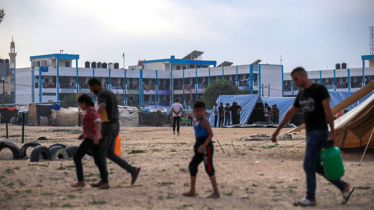People from northern Gaza are now staying in a UNRWA school in Rafah, southern Gaza Strip, amid ongoing conflicts between Israel and the Palestinian group Hamas. The war has displaced nearly 1.6 million Palestinians, according to UNRWA. Inside the school, already at full capacity, individuals have resorted to building tents around it due to the overwhelming demand for shelter. Hundreds of thousands now live in these cramped shelters with limited food and inadequate water. (Photo by Mohammed Zaanoun / Middle East Images / Middle East Images via AFP/Getty) 