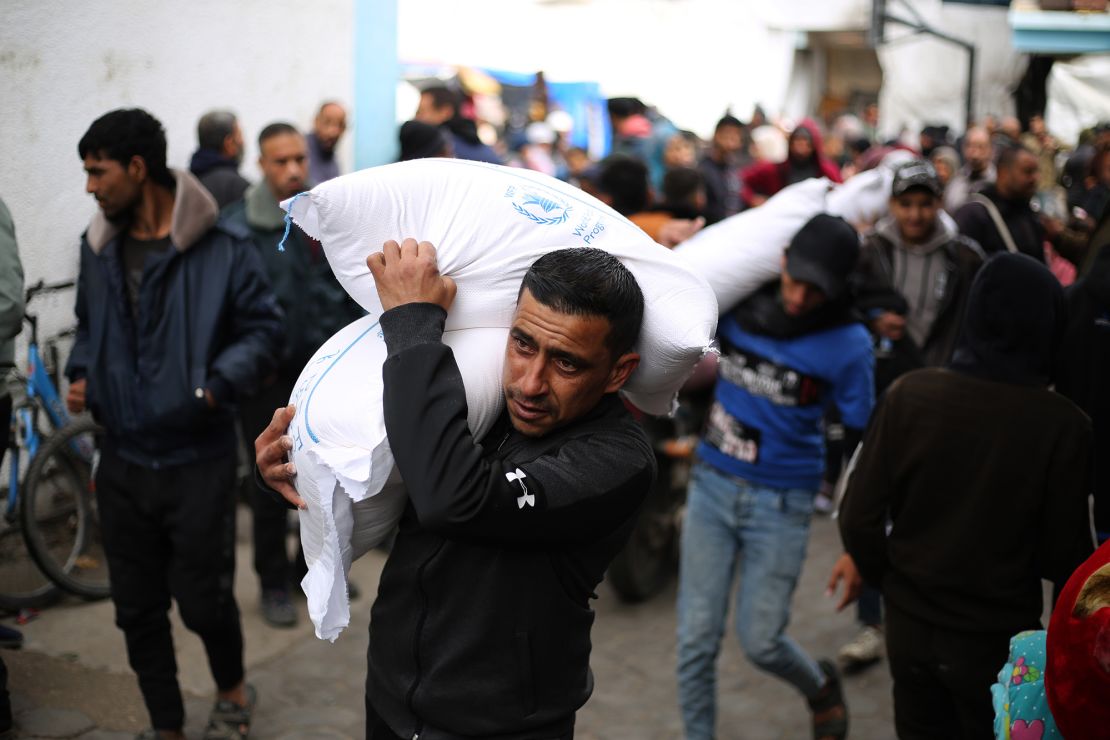 A man carries relief supplies provided by the United Nations Relief and Works Agency for Palestine Refugees UNRWA in the southern Gaza Strip city of Rafah, Jan. 28, 2024. Funding suspension would force UNRWA to halt all its activities in the conflict-ridden Gaza Strip in a few weeks, the UN relief agency's commissioner-general said Sunday. The United States, Canada, Britain, Germany, Australia, Finland, and the Netherlands decided to pause funding to UNRWA after Israel accused several UNRWA employees of suspected involvement in the Oct. 7 attack on Israel last year. (Photo by Khaled Omar/Xinhua via Getty Images)