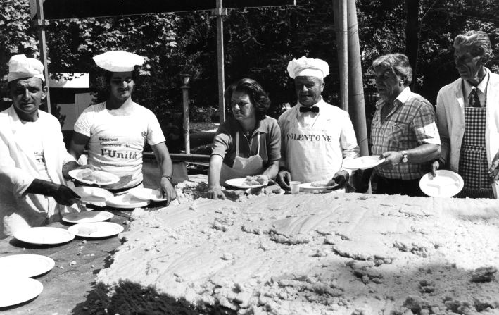 Italian Communist Party militants hand out servings of polenta during the Festa dell'Unita in Milan in 1979.  