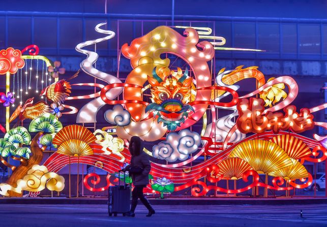 A woman walks past dragon-themed lanterns in Urumqi, Xinjiang Uygur Autonomous Region, China on February 7.