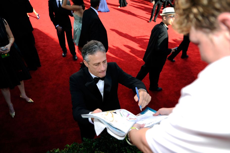 Stewart signs an autograph on the Emmys red carpet in 2009.