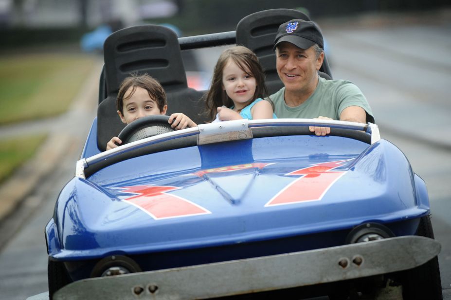 Stewart and his two children, Nathan and Maggie, take a ride on the Tomorrowland Speedway at Walt Disney World in Florida in 2011.