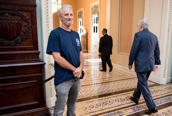 Stewart smiles as Senate Majority Leader Mitch McConnell walks by him on Capitol Hill in 2019. Stewart, who was in Washington, DC, to advocate for an extension of the 9/11 Victim Compensation Fund, had been sharply critical of McConnell in the past. Later in the day, <a href="https://www.cnn.com/2019/07/24/politics/john-feal-jon-stewart-9-11-fund-cnntv/index.html" target="_blank">the Senate passed the extension</a>, which would permanently compensate individuals who were injured during the 2001 terrorist attacks or the cleanup and rescue efforts.