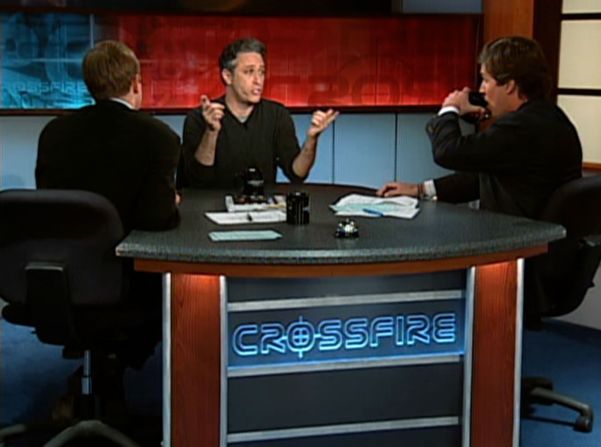 Stewart appears on an episode of CNN's "Crossfire" with Paul Begala, left, and Tucker Carlson in 2004. <a href="https://www.cnn.com/2019/06/12/entertainment/jon-stewart-crossfire/index.html" target="_blank">Stewart criticized the show and both men</a>, accusing them of "partisan hackery."
