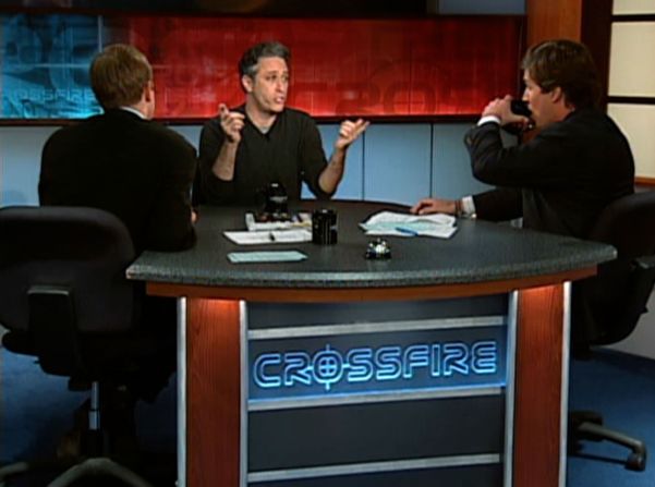 Stewart appears on an episode of CNN's "Crossfire" with Paul Begala, left, and Tucker Carlson in 2004. <a  target="_blank">Stewart criticized the show and both men</a>, accusing them of "partisan hackery."