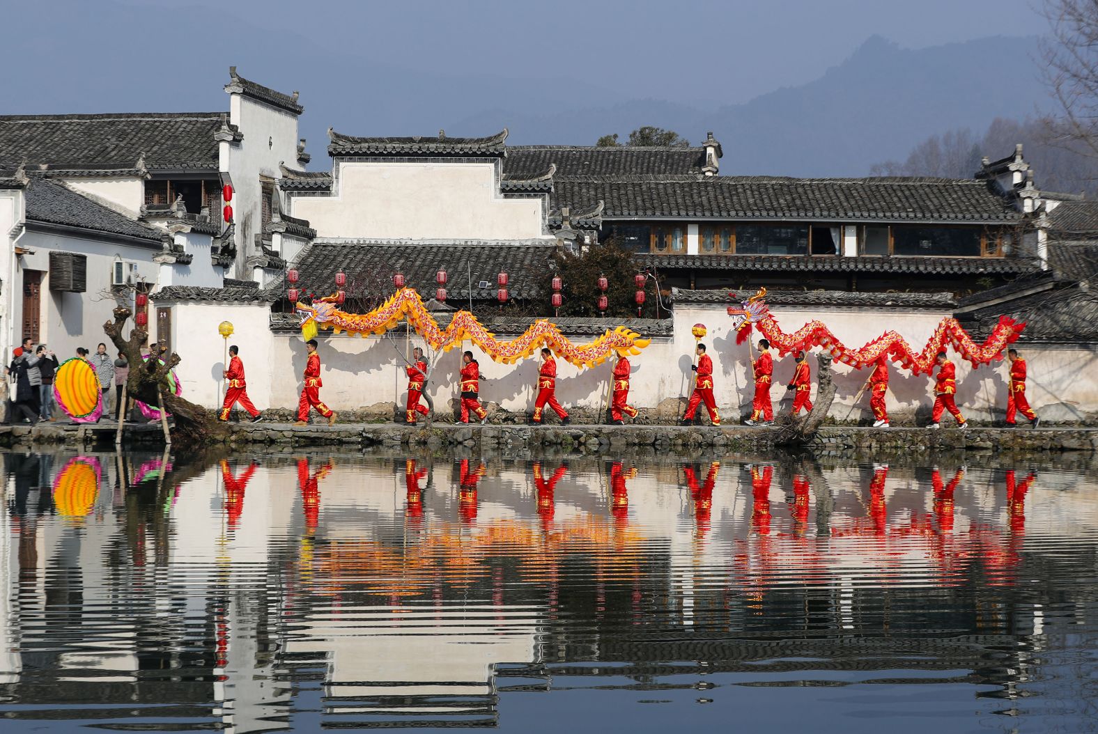 Members of a dragon dance team take part in a parade to celebrate the Lunar New Year on February 10, in Hongcun Village, China.