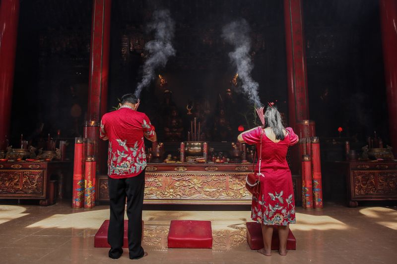 People attend prayers for Lunar New Year at Satya Dharma Temple in Bali, Indonesia, on February 10.