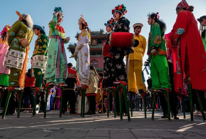 Traditional stilt walkers, or gaoqiao, wait to take part in a performance at a local temple fair in Beijing on February 10.