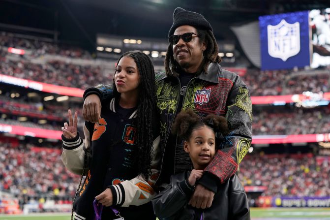 Rapper Jay-Z is seen with his two of his children, Blue Ivy and Rumi, before the game.