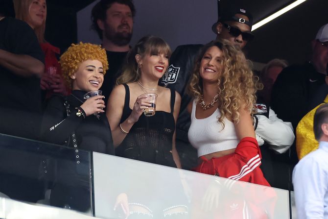 From left, rapper Ice Spice, Swift and Lively hang out before the start of the game.