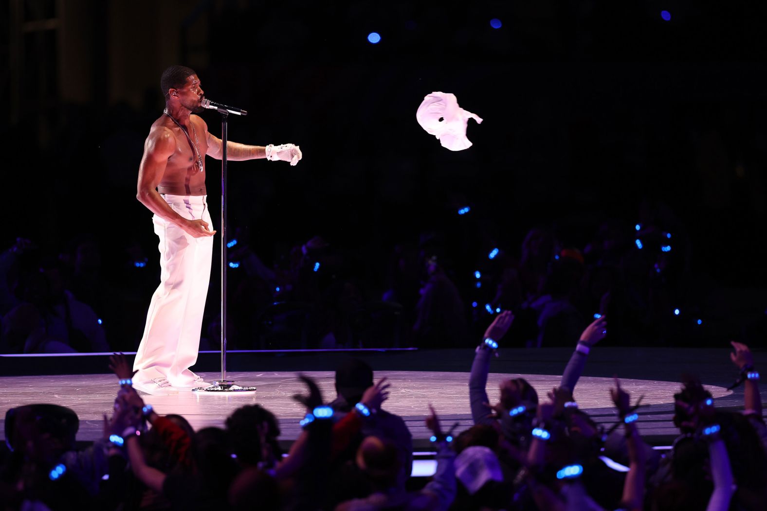 Usher removes his shirt while singing "U Got It Bad."