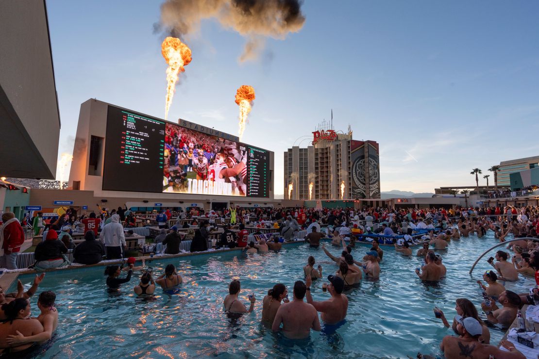 San Francisco 49ers fans celebrate a touchdown as they watch the Super Bowl 58 NFL football game against the Kansas City Chiefs from a pool on top of the Circa Resort and Casino, Sunday, Feb. 11, 2024, in Las Vegas. (AP Photo/Gregory Bull)