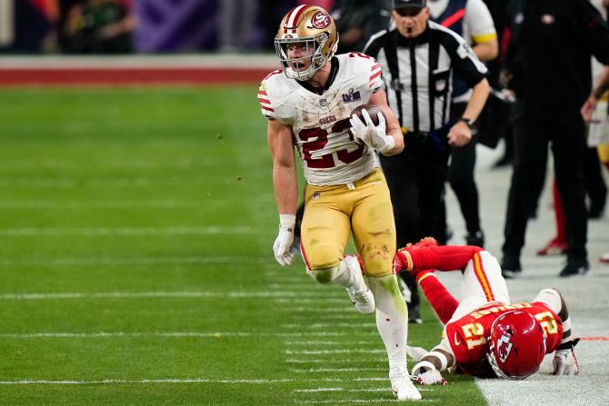 49ers running back Christian McCaffrey runs down the sideline for a big gain during overtime. The play set up a Jake Moody field goal that gave the 49ers a 22-19 lead.