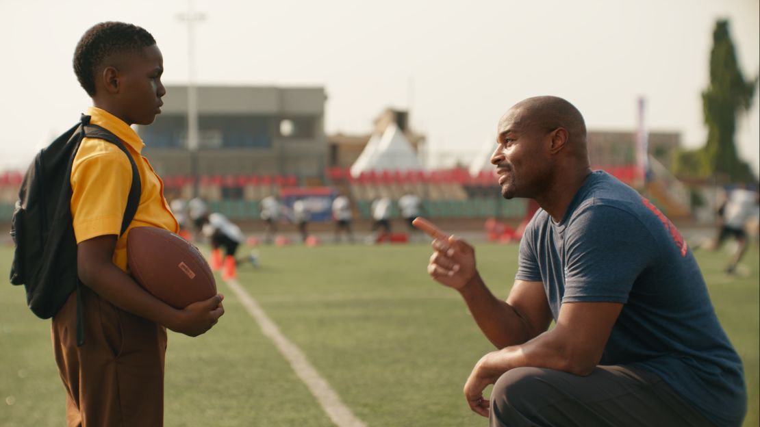 Umenyiora greets the boy, played by Eldad Osime, at the NFL camp during the commercial.
