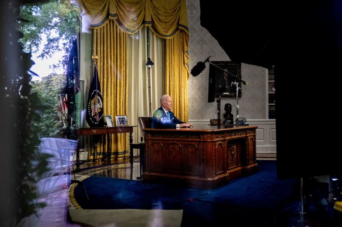 Biden, seen through a window, delivers his first-ever address from the White House Oval Office on June 2, 2023. He declared bipartisanship alive and well as he <a href="https://www.cnn.com/2023/06/02/politics/biden-debt-oval-office-address/index.html" target="_blank">pointed to the compromise</a> measure that raised the federal borrowing limit and avoided a catastrophic default. 