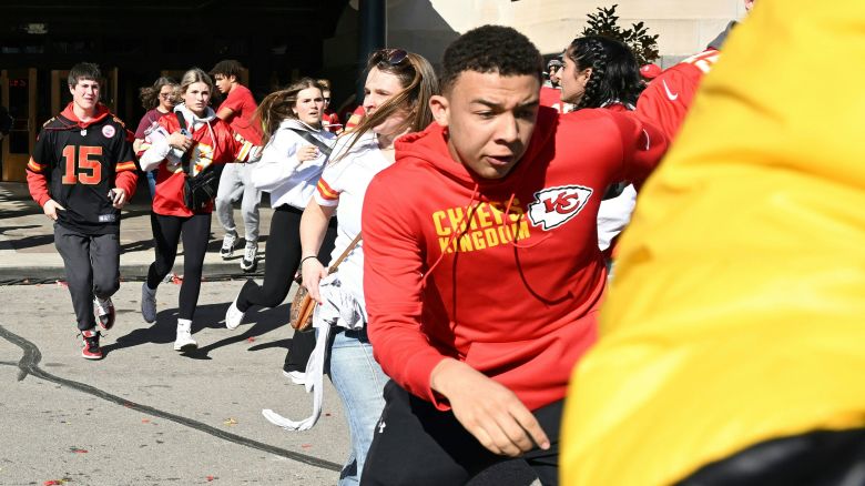 TOPSHOT - People flee after shots were fired near the Kansas City Chiefs' Super Bowl LVIII victory parade on February 14, 2024, in Kansas City, Missouri. (Photo by ANDREW CABALLERO-REYNOLDS / AFP) (Photo by ANDREW CABALLERO-REYNOLDS/AFP via Getty Images)