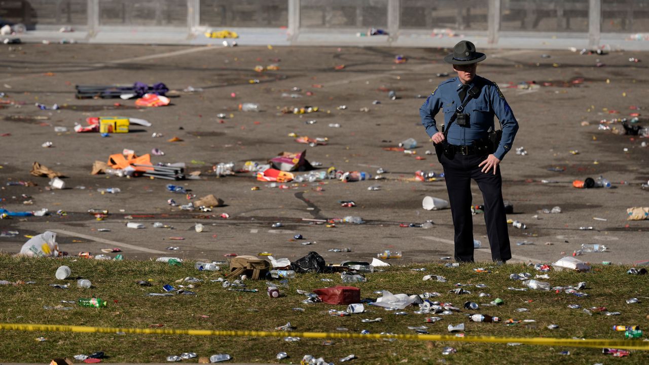 A law enforcement officer looks around the scene following a shooting at the Kansas City Chiefs NFL football Super Bowl celebration in Kansas City, Mo., Wednesday, Feb. 14, 2024. Multiple people were injured, a fire official said.(AP Photo/Charlie Riedel)