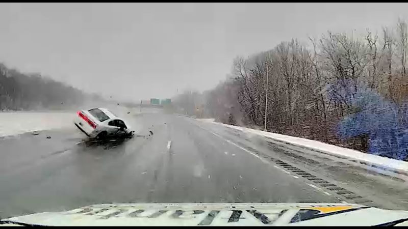 Car flipping across highway narrowly misses ambulance