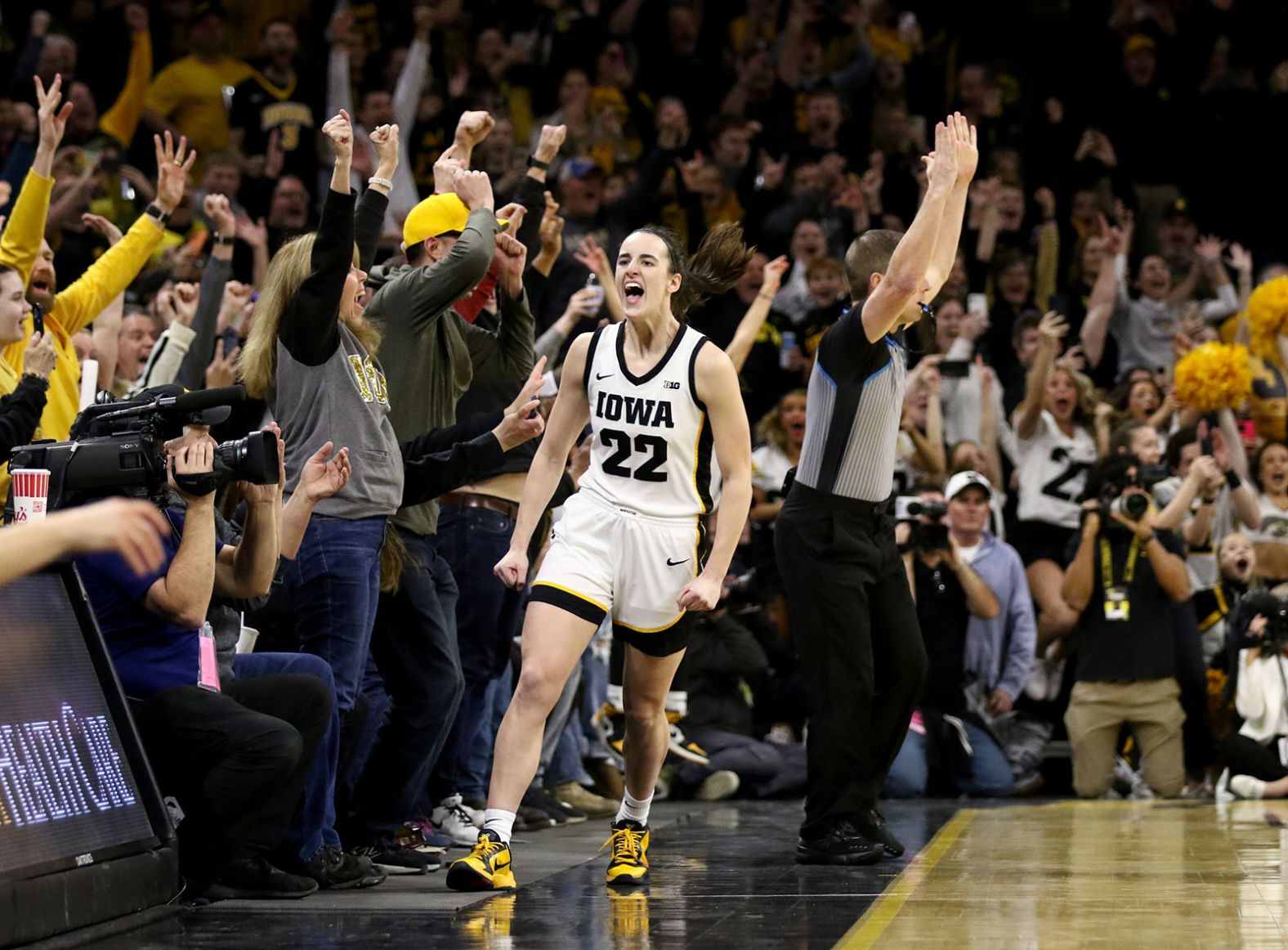 Iowa star Caitlin Clark celebrates after she hit a 3-pointer against Michigan <a href="index.php?page=&url=https%3A%2F%2Fwww.cnn.com%2F2024%2F02%2F15%2Fsport%2Fcaitlin-clark-ncaa-scoring-record-spt-intl%2Findex.html" target="_blank">to become the all-time leading scorer in NCAA women's basketball</a> on Thursday, February 15. Clark surpassed the previous record of 3,527 career points, which was set by Kelsey Plum.