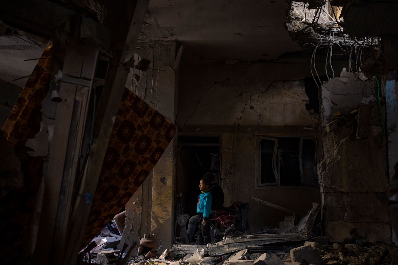A Palestinian child looks at damage to his family's house after an Israeli strike in Rafah, Gaza, on Thursday, February 8. <a href="index.php?page=&url=https%3A%2F%2Fwww.cnn.com%2F2024%2F02%2F14%2Fmiddleeast%2Frafah-international-opposition-israel-ground-offensive-intl-hnk%2Findex.html" target="_blank">Israel has been bombarding Rafah with airstrikes and shelling for weeks</a> as it continues its war against the Hamas militant group that attacked the country in October.